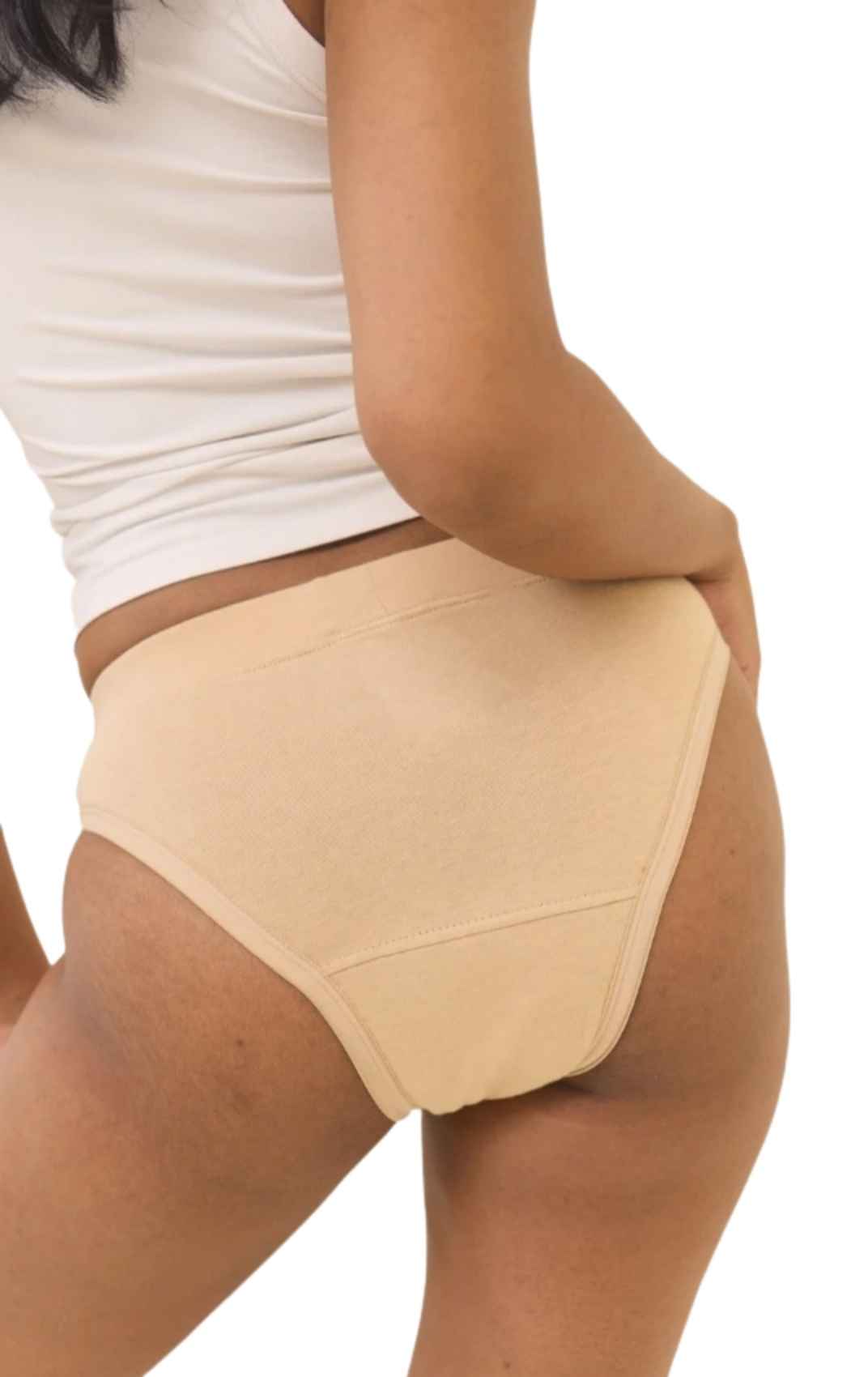 Ride or Dry leakproof underwear in Oatmeal: side view of seamless high-waisted briefs in light beige with a white tank top against a white background.